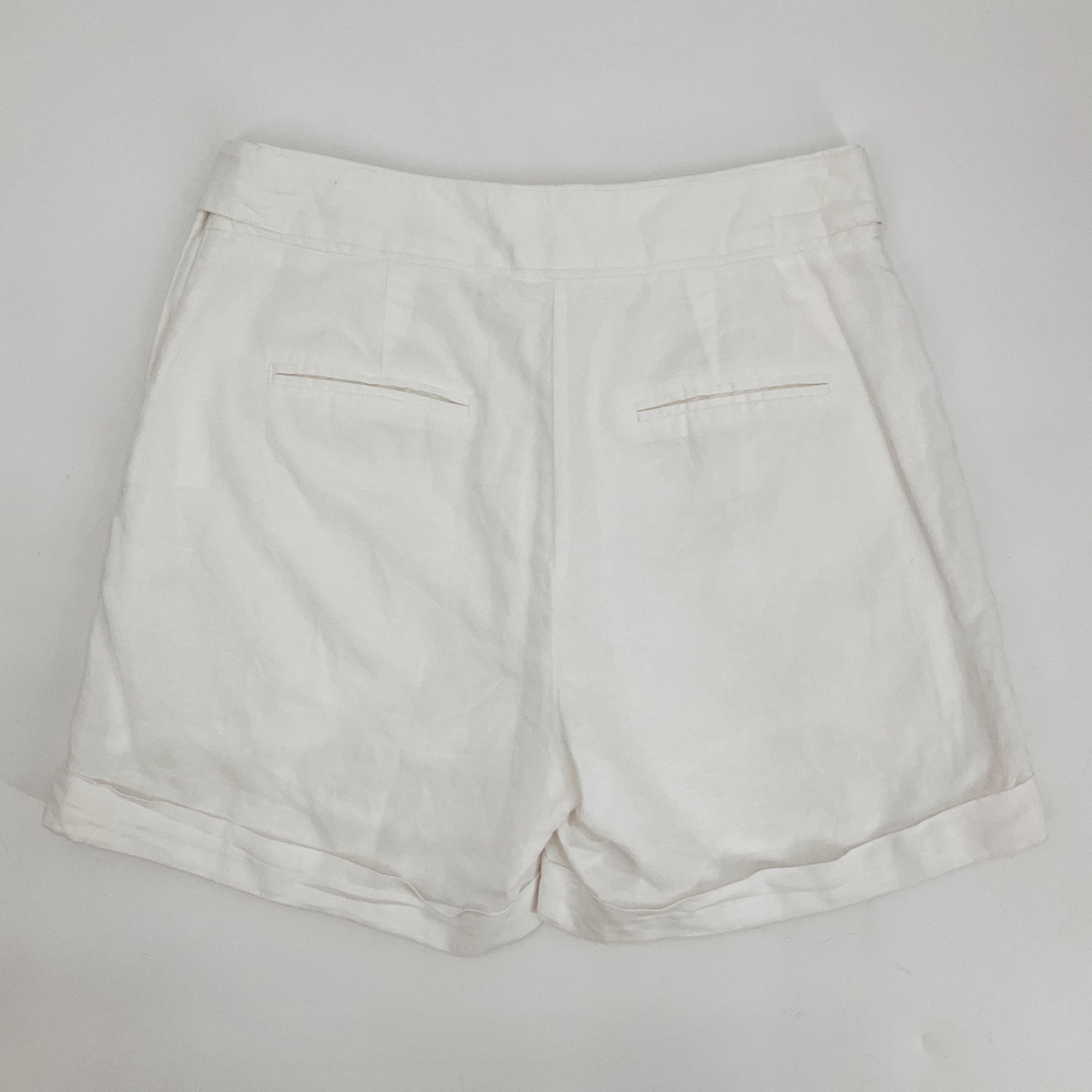 High-waisted white cuffed shorts by a loves a, featuring pleats, perfect for casual and resort wear. Size 2.