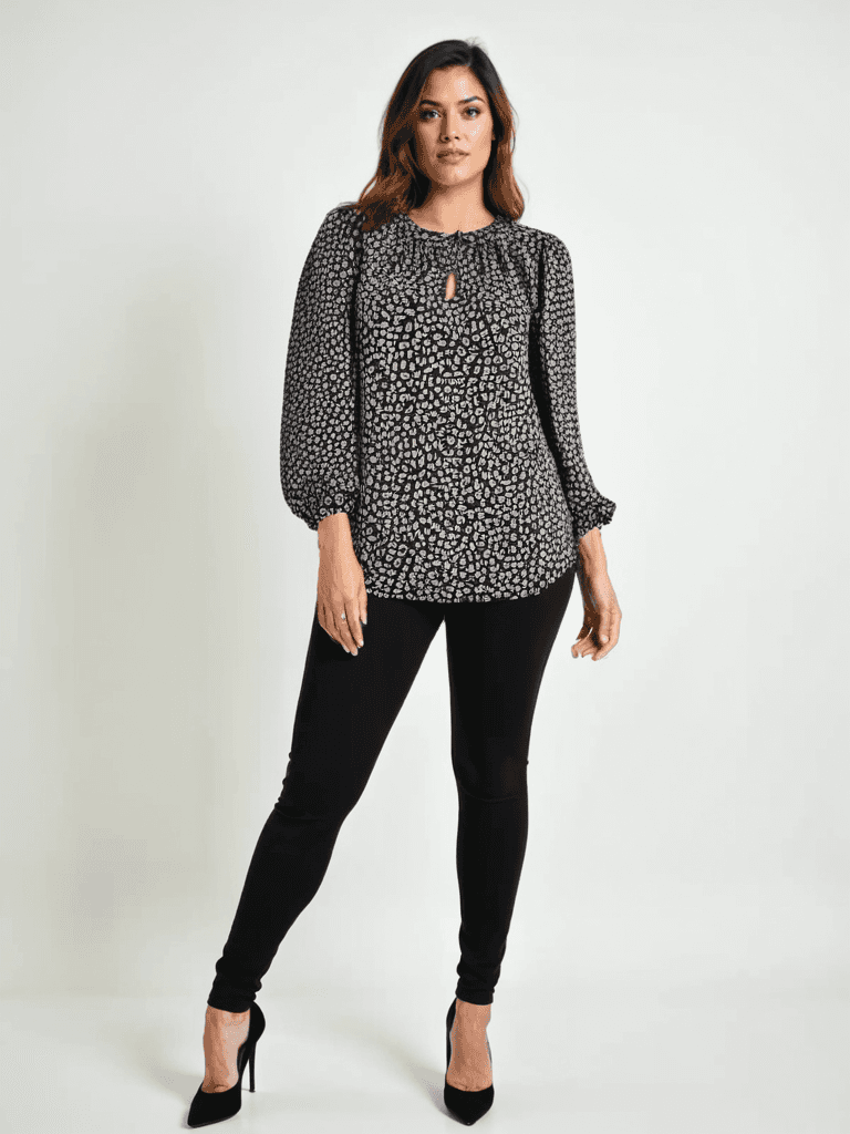 Loft Top Size Small from Margaret’s Fine Consignments styled on model; black, white, and red print long sleeve casual top with keyhole neckline.