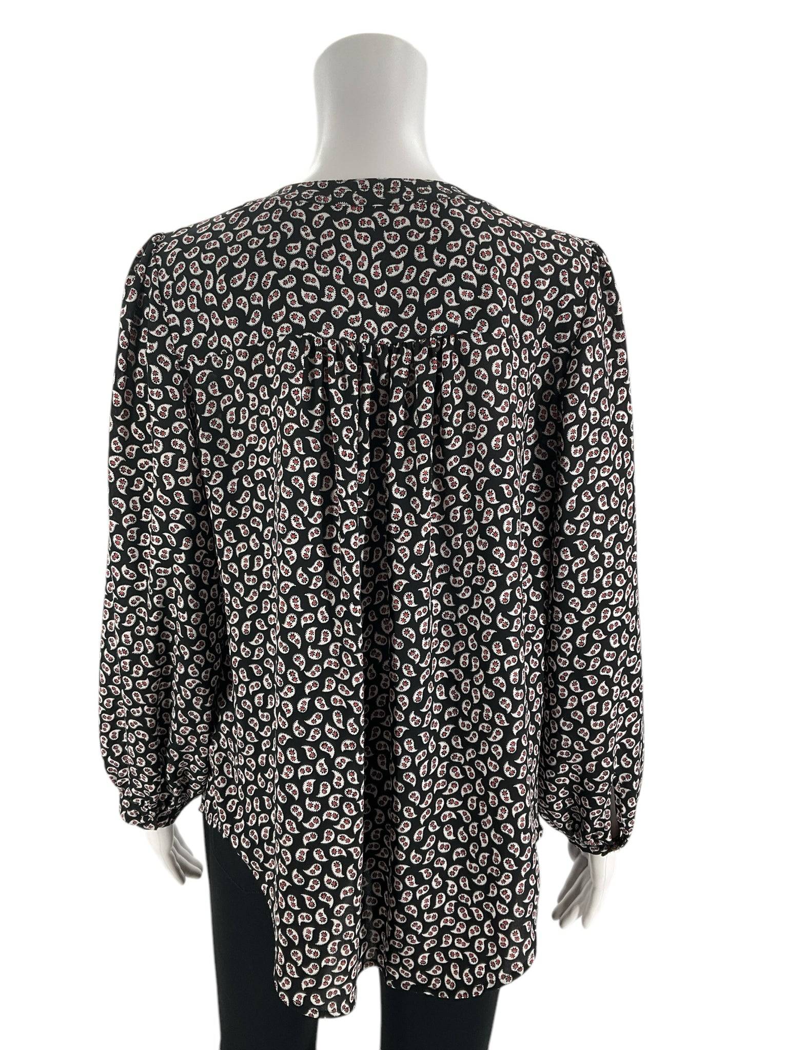 Back view of Loft Top Size Small from Margaret’s Fine Consignments; features pleated detail and relaxed fit in black, white, and red print.
