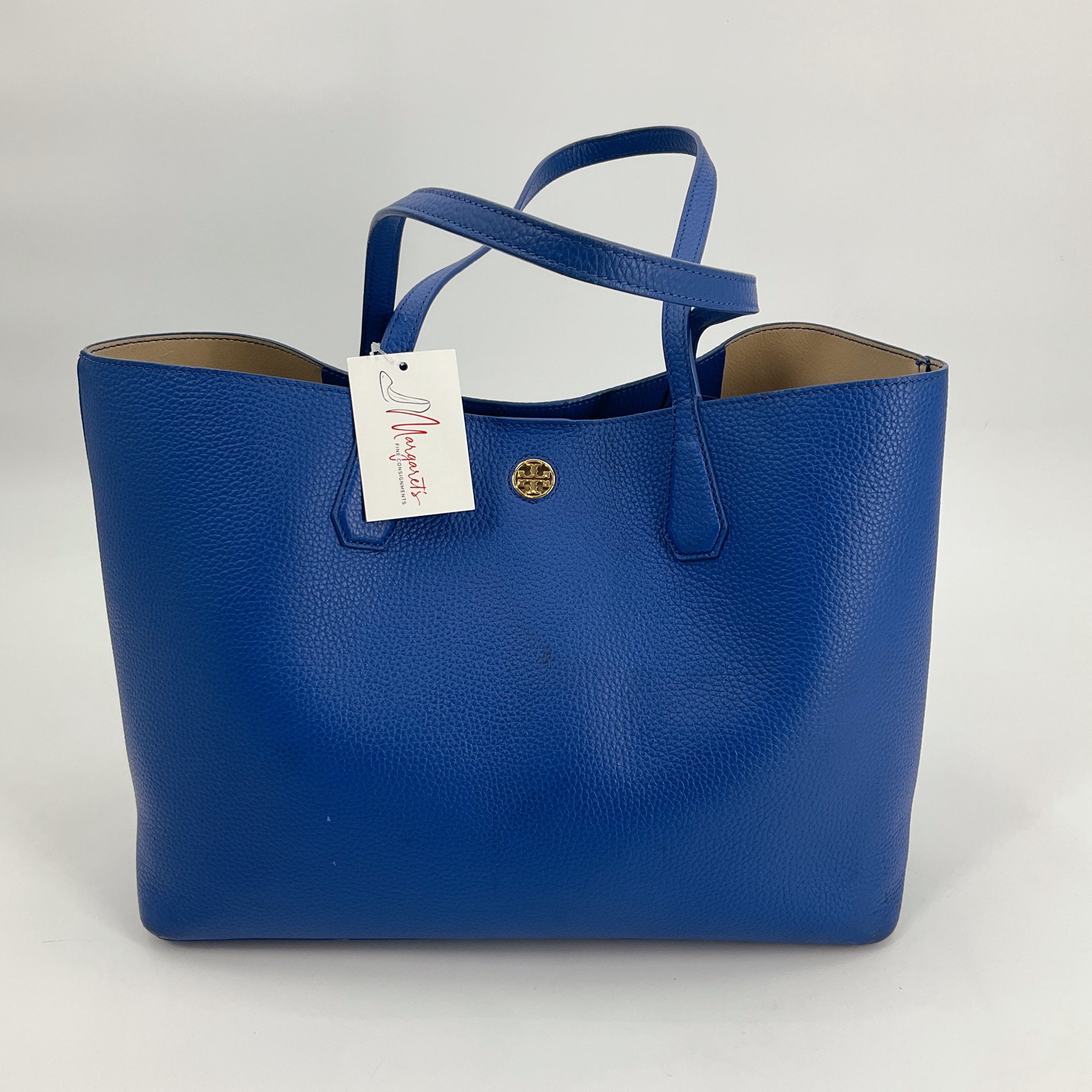 Tory Burch Blue Pebble Tote Bag with gold logo emblem, gently used and available at Margaret's Fine Consignments. Spacious leather purse with dual handles.