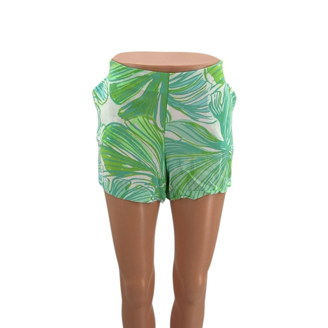 Front view of Lilly Pulitzer Shorts Size 10 featuring a vibrant white, green, and blue palm leaf pattern, sold by Margaret’s Fine Consignments.
