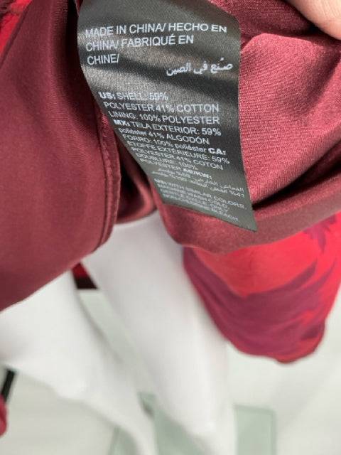 Close-up of fabric tag showing material composition of White House Black Market Dress Size 10, available at Margaret’s Consignments.