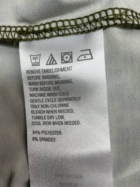 Care label of C Wonder Top Size 1X showing fabric composition of 94% polyester and 6% spandex with washing instructions.