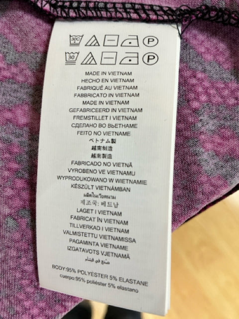 Care label of MICHAEL Michael Kors fuchsia snakeprint dress showing fabric composition of 95% polyester and 5% elastane, made in Vietnam.