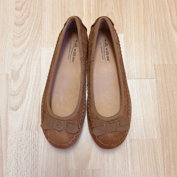 Coldwater Creek Camel Suede Flats - Size 8 with bow detail, slip-on style, displayed on wooden floor. Pre-loved shoes available at Margaret’s.