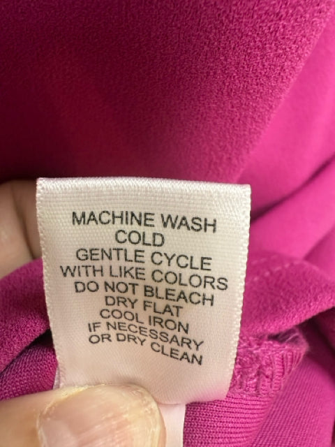 Care label for Spence Fuchsia Pink Asymmetrical Ruffle Sheath Cocktail Dress Size 8 with machine wash instructions and fabric care guidelines.
