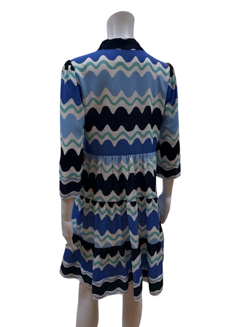 Back view of Sail to Sable Tiered Tunic Dress in wave stripe print, showcasing its relaxed fit and coastal resort wear style.