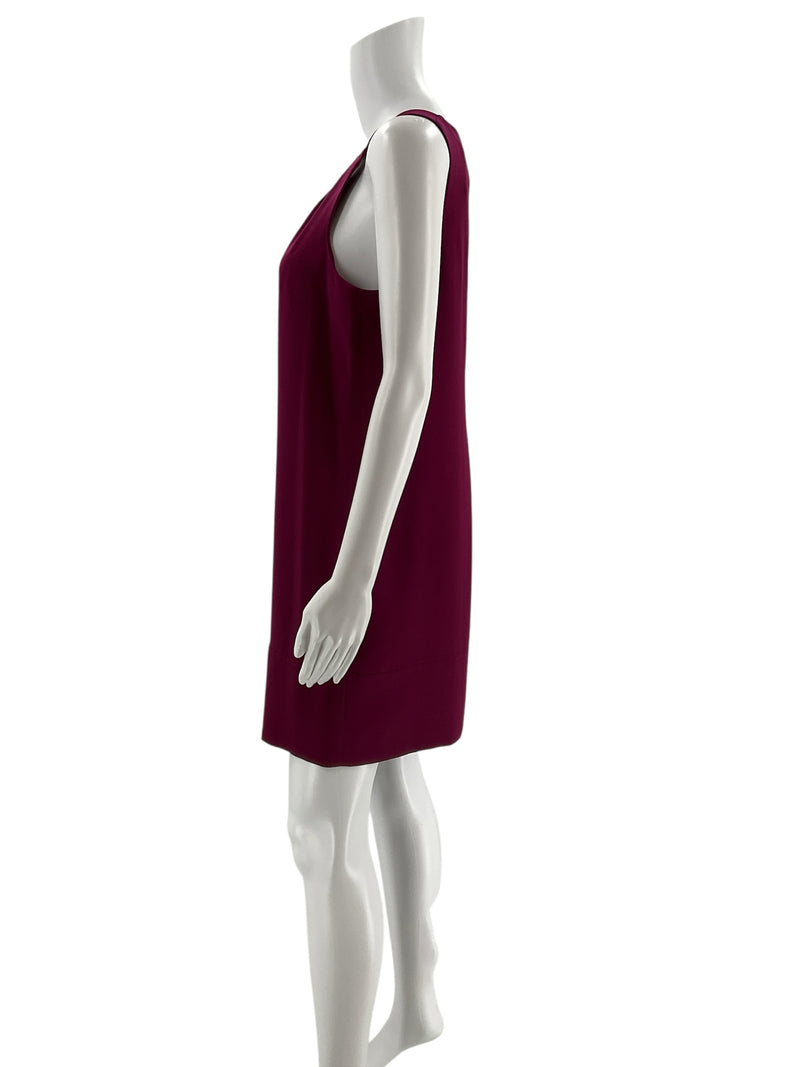 Side profile of Oleg Cassini plum shift dress size 6 on mannequin, highlighting sleeveless cut and smooth crepe fabric for elegant styling.