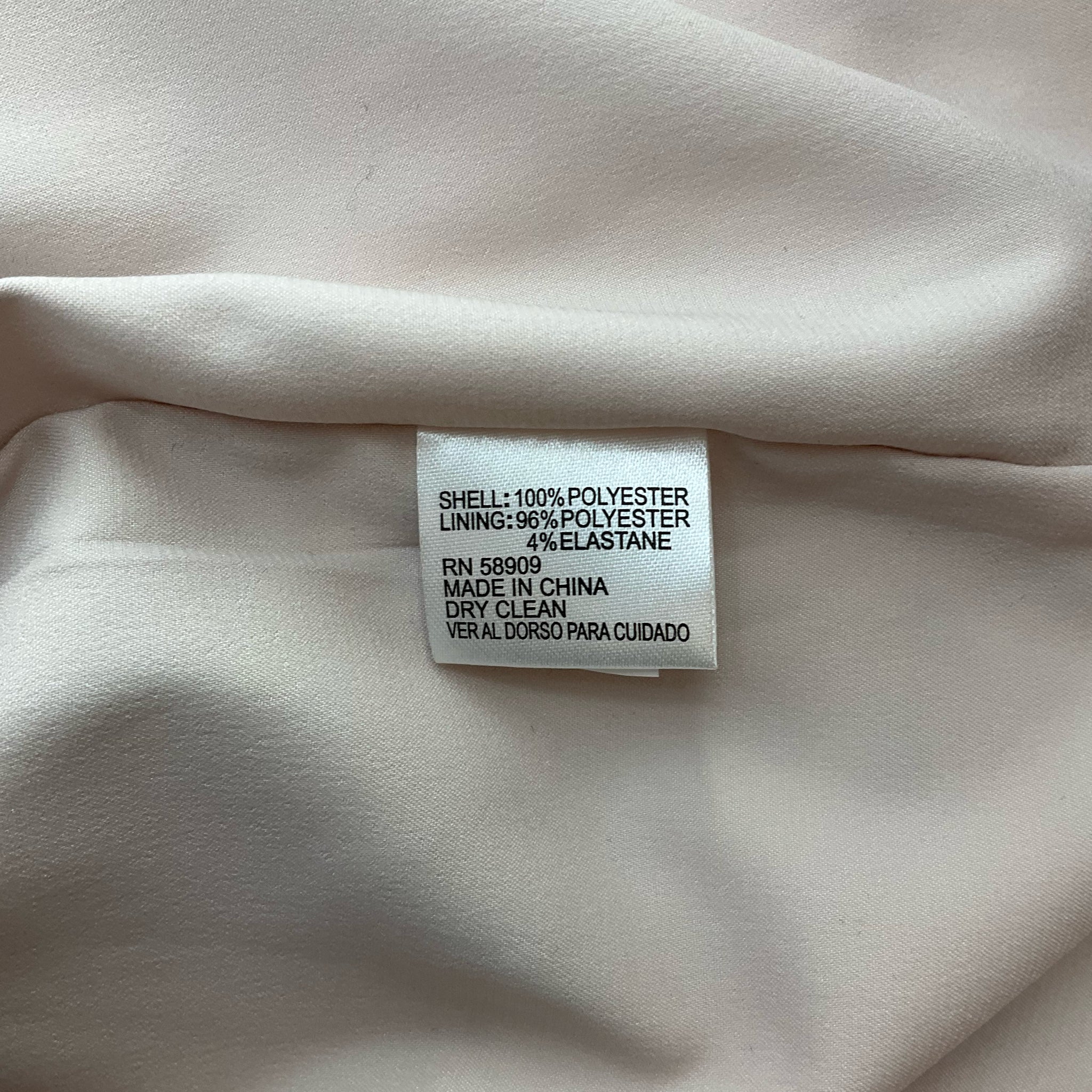 Fabric care tag of Gianni Bini Yellow/Blue Floral Dress - Size Large | Shows polyester shell and lining with elastane, dry clean only.