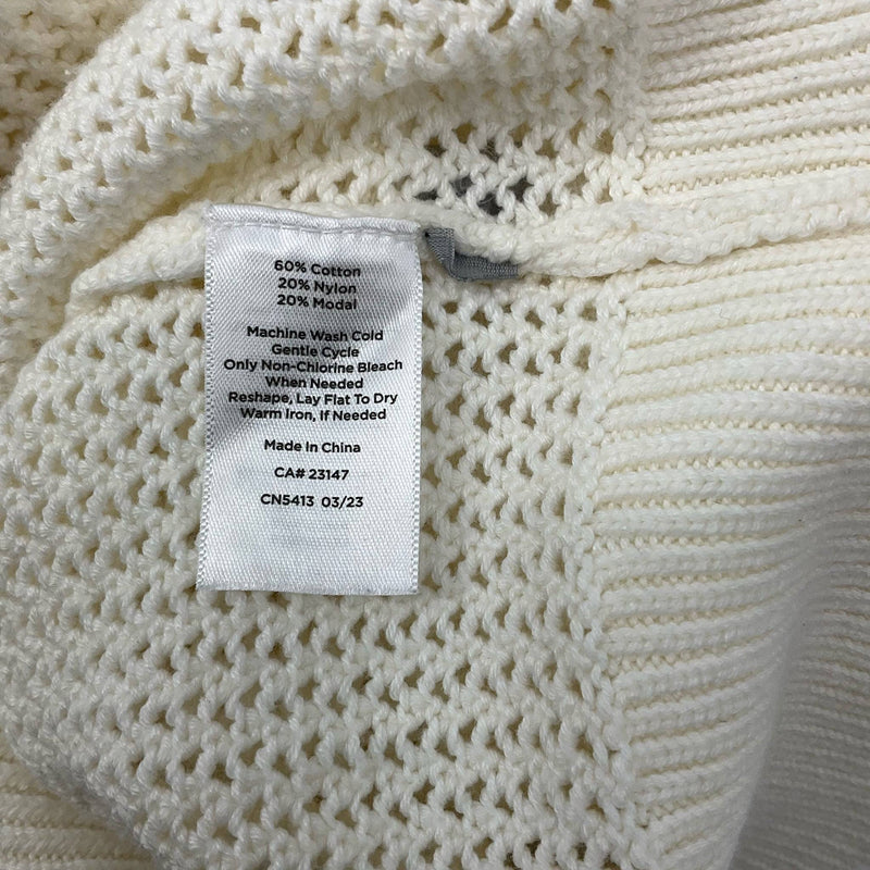 Fabric care label of T by Talbots Top Size Large showing cotton, nylon, and modal blend, available at Margaret’s Fine Consignments.