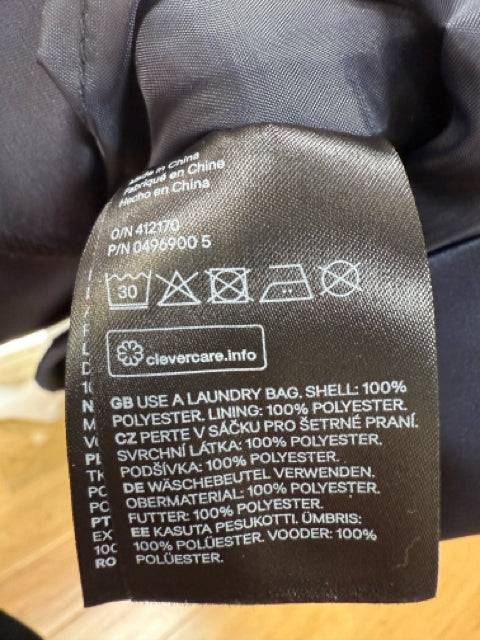 Close-up of care label for H & M Strapless Mini Dress Size 10, showing 100% polyester material and washing instructions, from Margaret’s Fine Consignments.