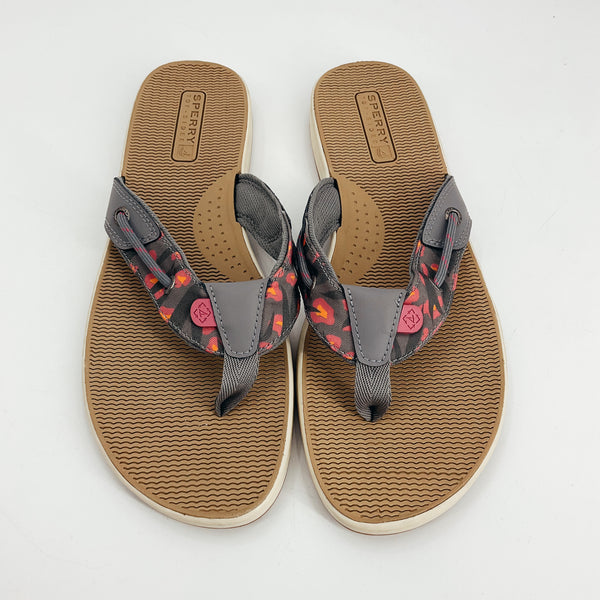 Top view of Sperry Gray/Pink Print Pre-Owned Ladies Flip Flop - Size 10, featuring abstract pink accents and durable thong straps for casual summer use.