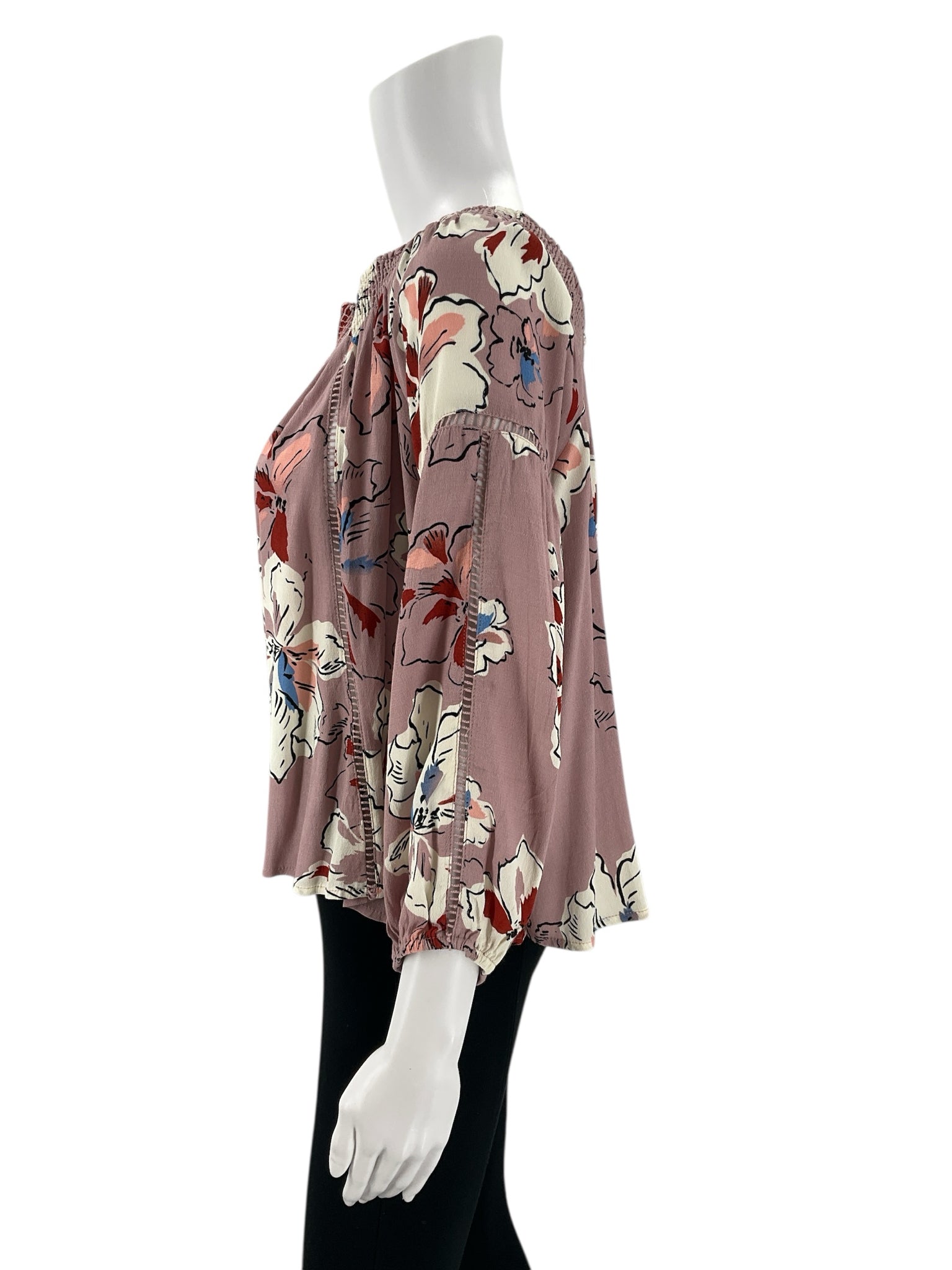 Side profile of Astr Dusty Lavender/Multi Floral Top - Size Medium featuring loose sleeves and floral design, ideal for casual wear.