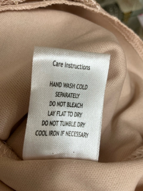 Care instructions tag for Emerald Sundae tan lace dress, recommending hand wash cold, lay flat to dry, and cool iron if needed.