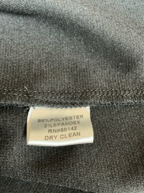 Close-up of fabric tag showing 98% polyester and 2% spandex blend with RN#58142, indicating dry clean only care instructions.