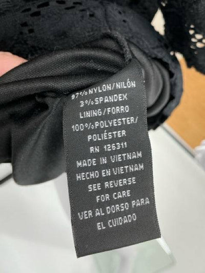 Black eyelet ladies dress by Ronni Nicole, size 12, featuring detailed fabric and a classic silhouette.