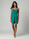B Darlin green spaghetti strap mini dress size 11/12 modeled, available at Margaret’s Fine Consignments, perfect for casual or special occasions.