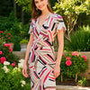 Model wearing Joseph Ribkoff pink and white print knee-length dress size 6 with cap sleeves, available at Margaret’s Fine Consignments.