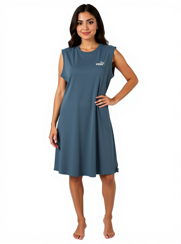 Puma Essentials Blue Teal Logo Tank Dress in size Medium modeled on a woman, ideal for casual or athletic wear with a relaxed fit.