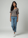 Model wearing Lilla P Top Size Small in red and white knit, styled with blue jeans and white sneakers, available at Margaret’s Fine Consignments.