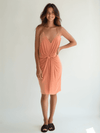 MISA Mini Dress Size Medium in peach with spaghetti straps and front knot detail, modeled for Margaret’s Fine Consignments.