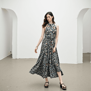 Model wearing Elliatt Halther Maxi Dress Size Small in blue and peach floral print, available at Margaret’s Fine Consignments.