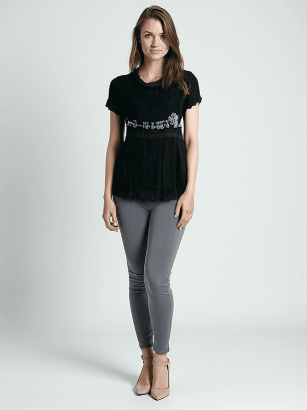 Johnny Was Top Size XS styled on model, featuring black beaded detailing and relaxed fit from Margaret’s Fine Consignments.