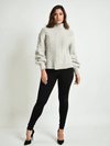 Gap Sweater Size Small styled with black leggings and heels, available at Margaret’s Fine Consignments. Cozy tan knit top with cable detailing.