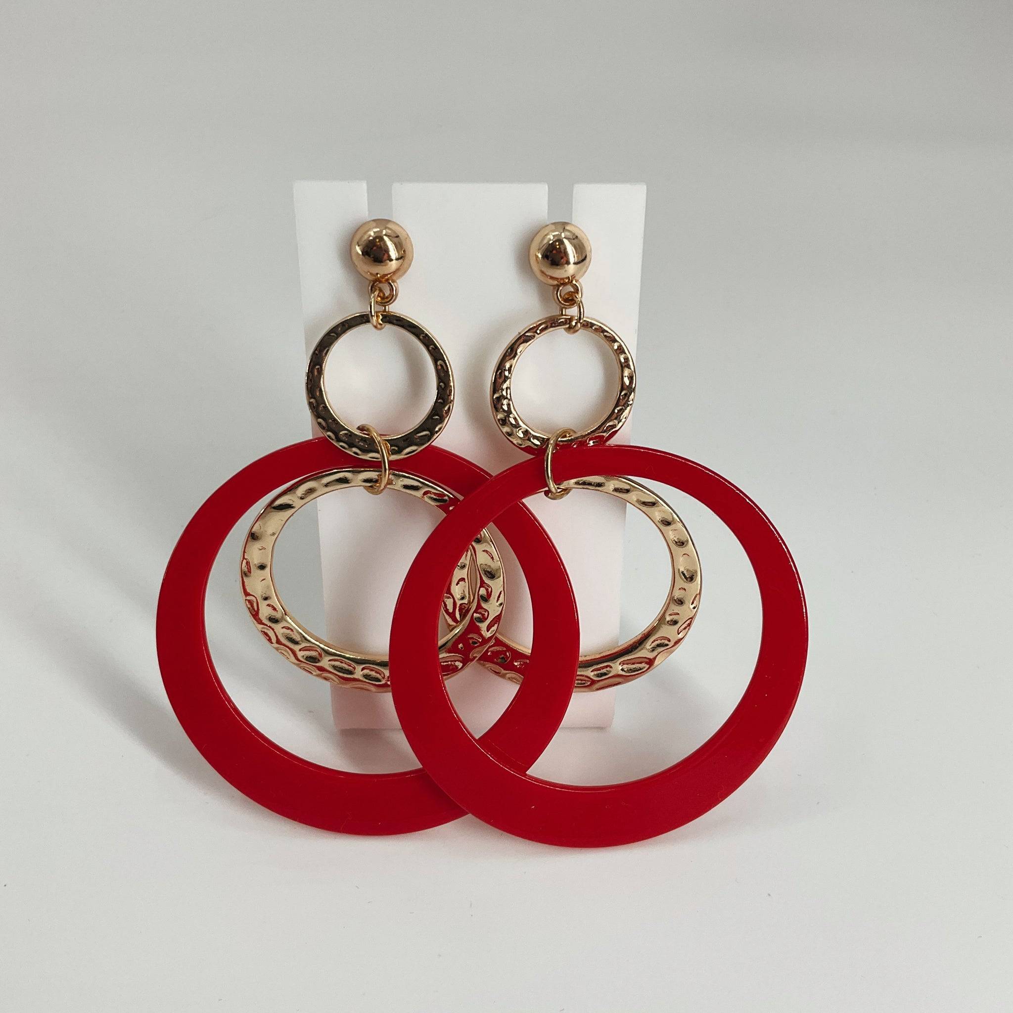 Bold red and gold-tone circular drop earrings with textured metal rings, stylish statement jewelry for women. Earrings from category: Earrings, Item ID: 650130.