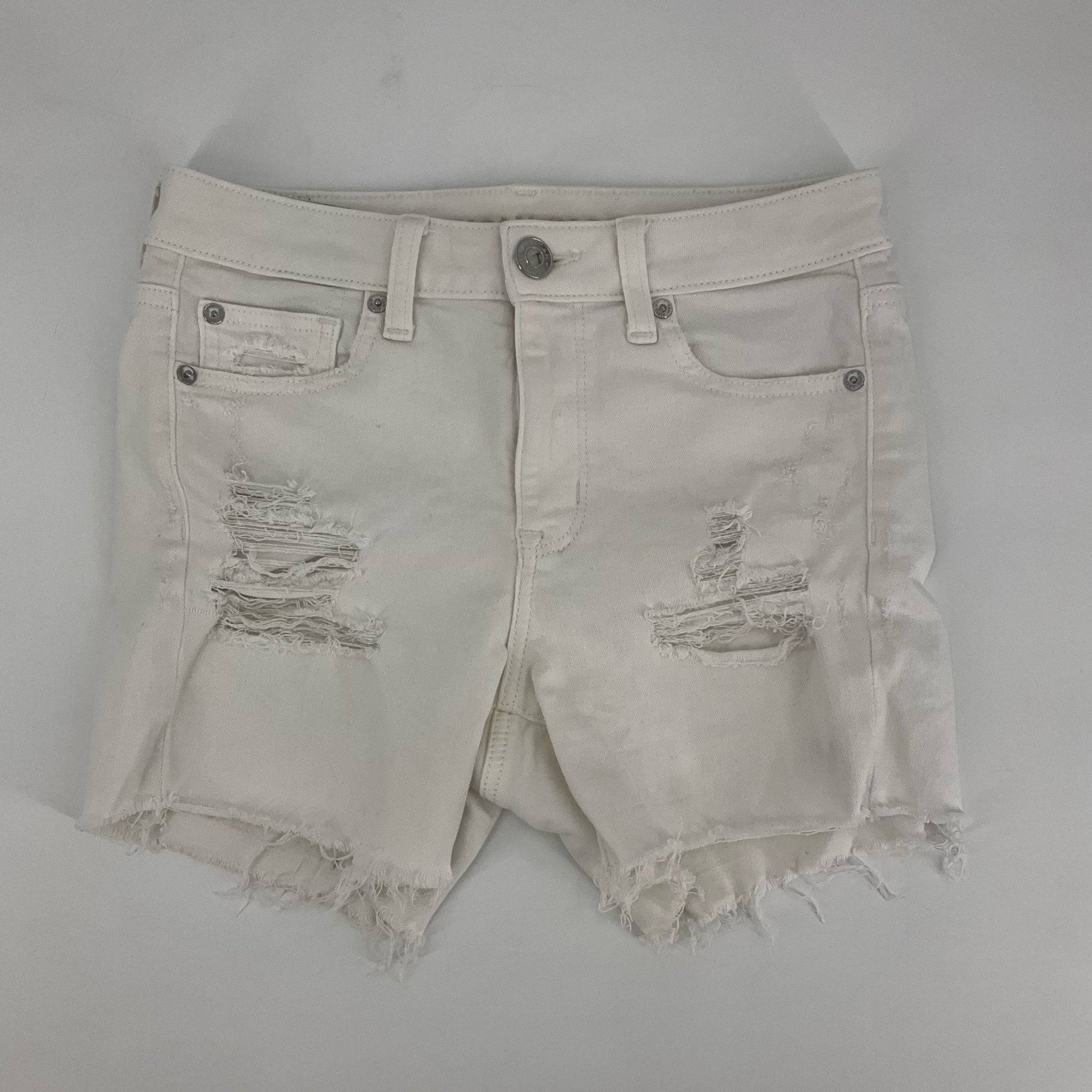 Front view of american eagle Size 4 White ripped Shorts with distressed detailing and frayed hems, ideal for casual summer wear.