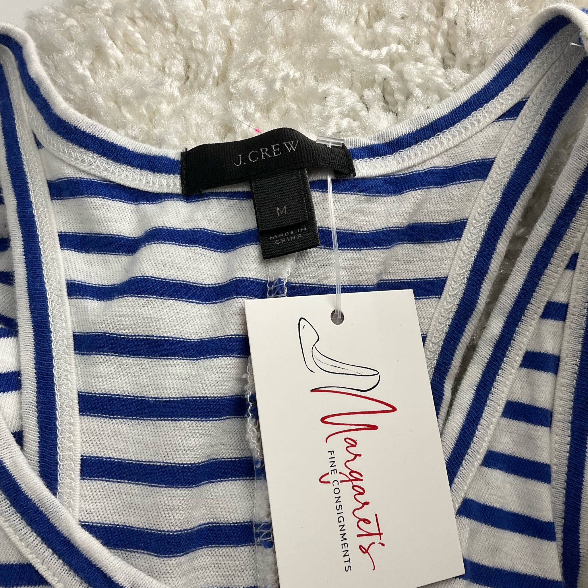 Close-up of J Crew label on White/Blue Stripe Dress - Size Medium, confirming brand and size, sold pre-owned at Margaret’s Fine Consignments.