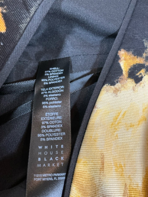 Close-up of fabric tag on WHBM Black & Yellow Floral Dress, detailing cotton-spandex blend for comfort and stretch in size 8.