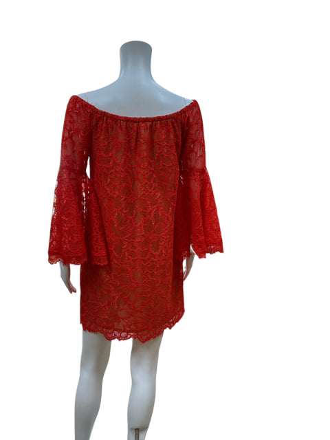Back view of Trina Turk orangish/red off the shoulder lace dress on mannequin, showcasing scalloped hem and bell sleeves. Size 2.
