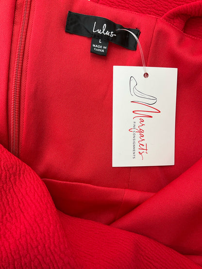 Close-up of Lulus dress label and consignment tag, confirming authenticity of the pre-owned Remarkable Presence red midi dress in size large.