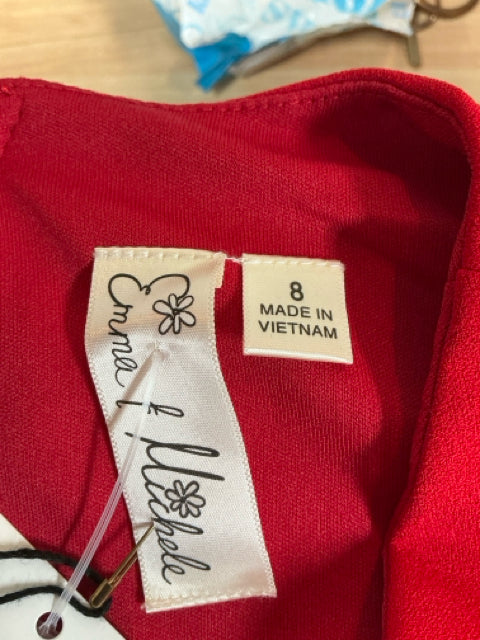Brand label inside Emma Michele red dress showing size 8 and made in Vietnam, attached to new with tags item.