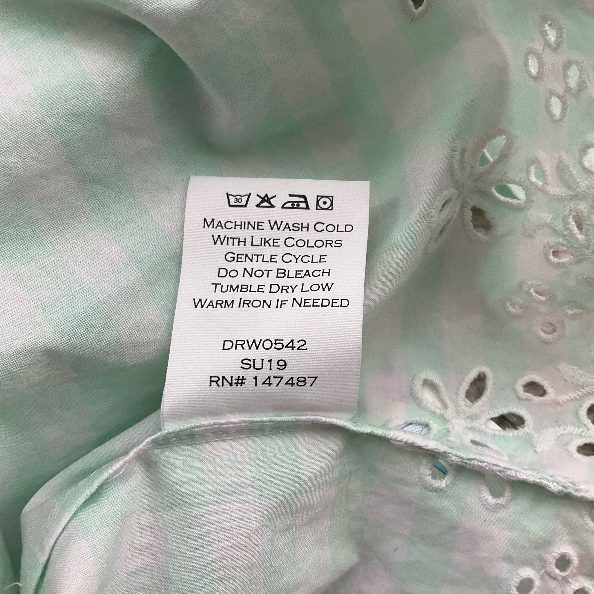 Care label on Draper James Dress Size 6 with washing instructions and product code DRW0542 SU19, ensuring proper garment maintenance.