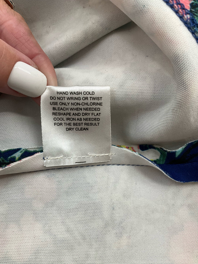 Care label for Pink Rose floral sleeveless dress, recommending hand wash cold and dry flat, suitable for delicate fabric care.
