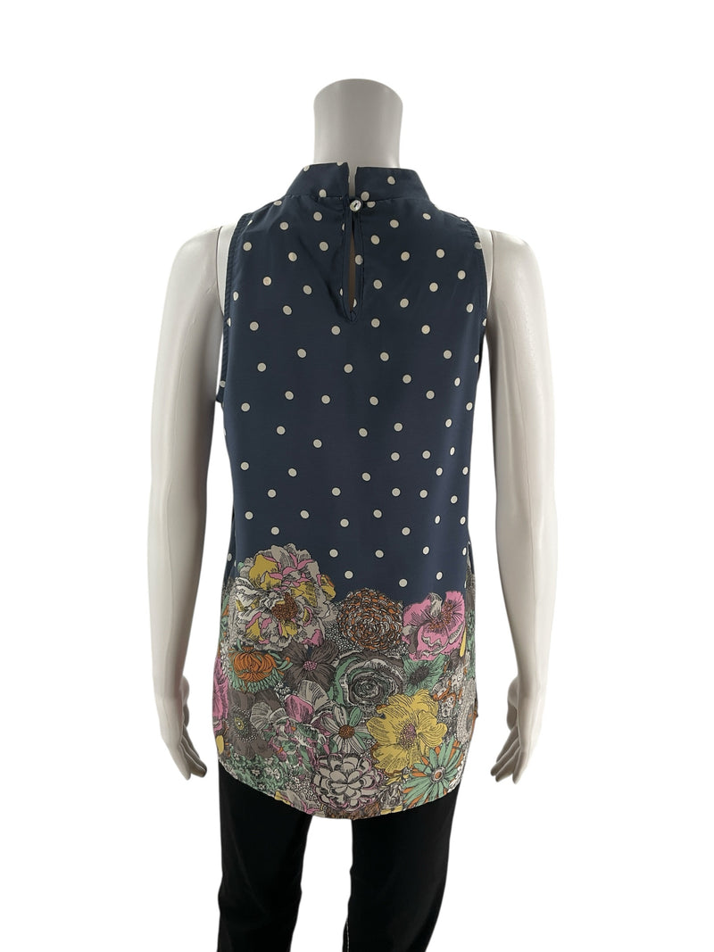 Back view of Les Amis blue polka dot sleeveless blouse with keyhole closure and floral print hem, size small, ideal for feminine casual outfits.