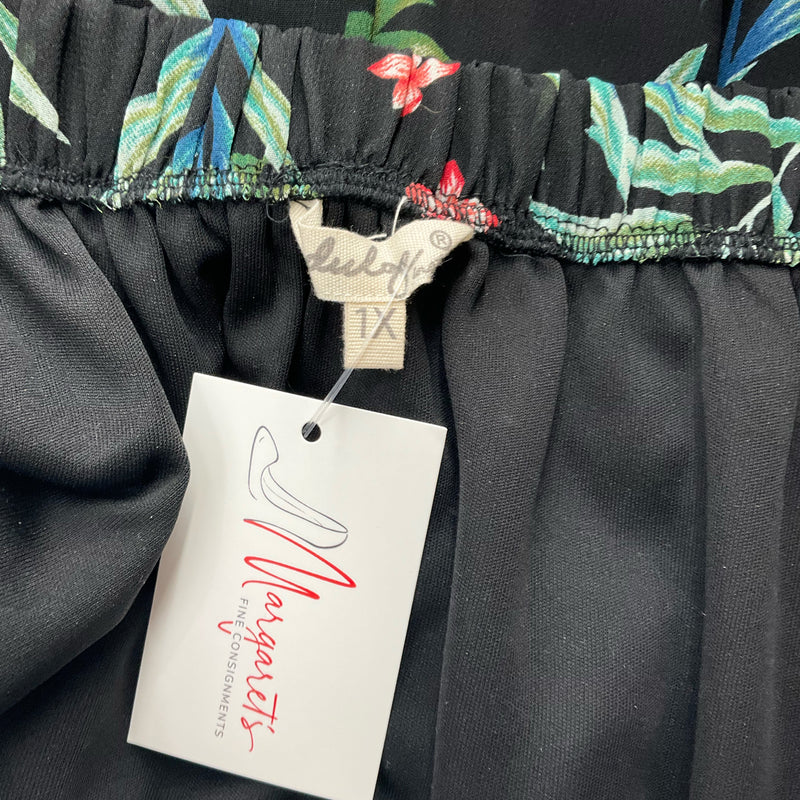 Close-up of Indulge brand tag on Leaf Print Pre-Owned Romper - Size 1X, confirming authenticity and size for plus-size fashion shoppers.