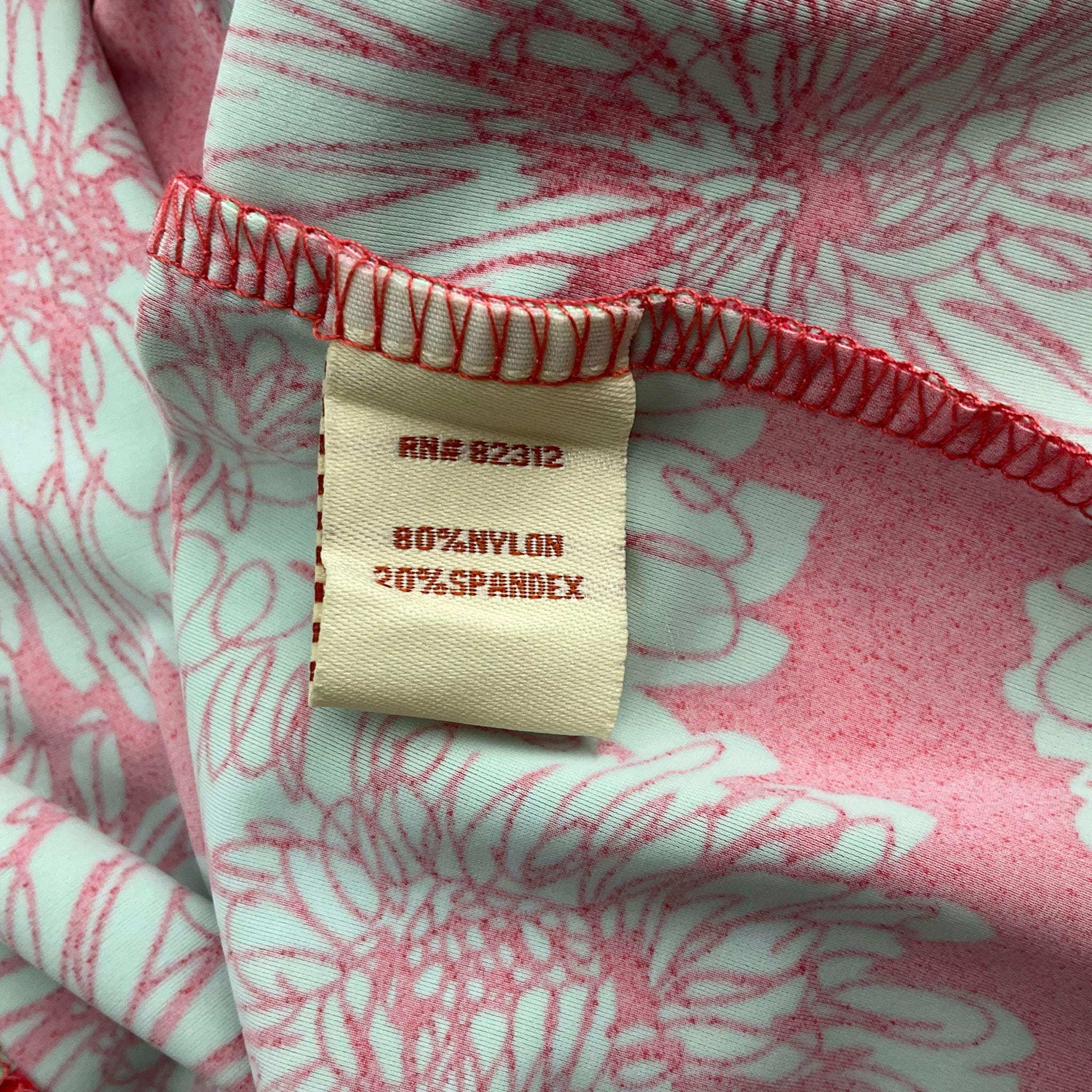 Fabric tag of Aryeh Coral/Green Print Dress - Size Large showing 80% nylon and 20% spandex blend for stretch and comfort.