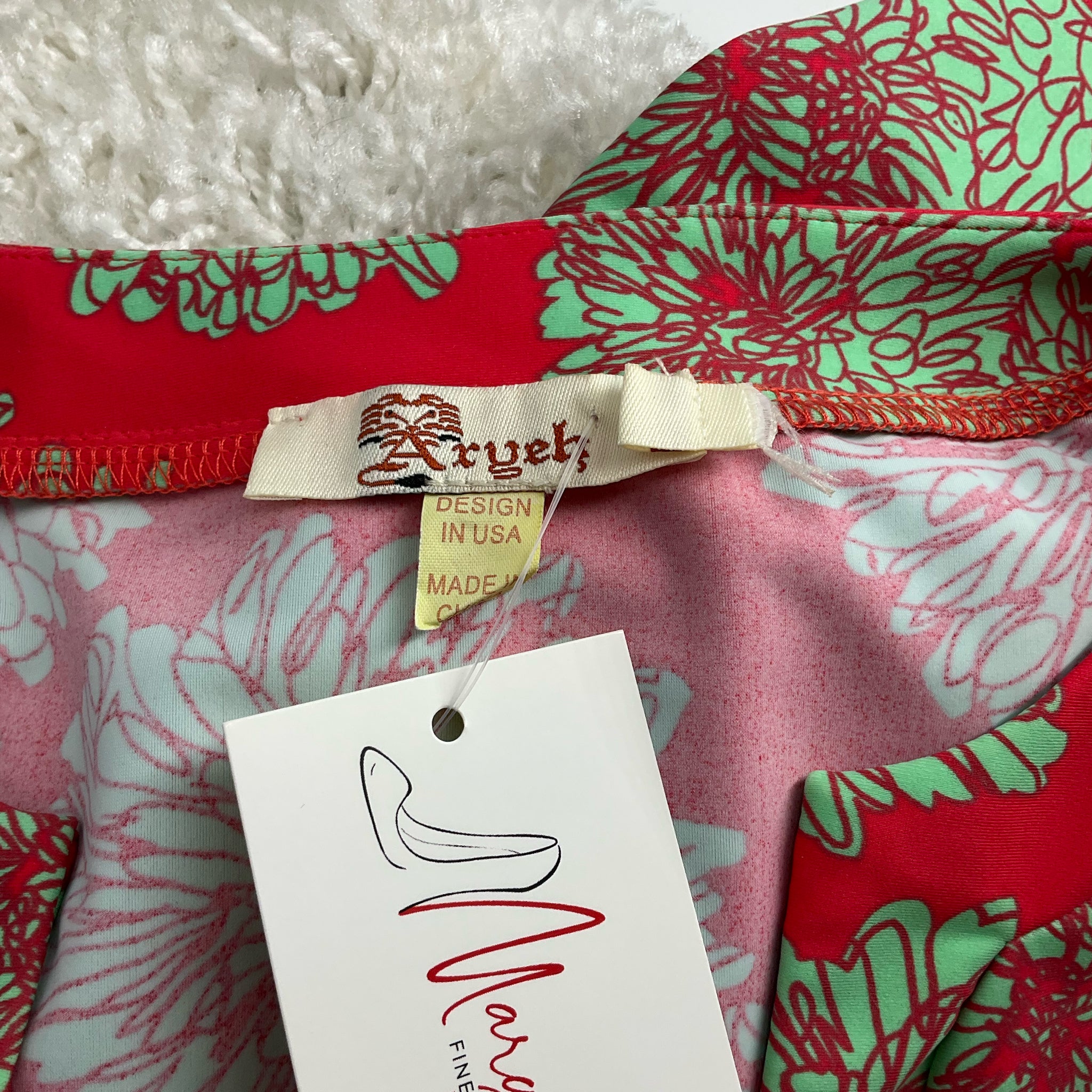 Close-up of Aryeh brand label on Coral/Green Print Dress - Size Large, confirming authenticity and USA design.