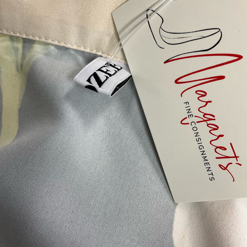 Close-up of Uoozee dress brand tag attached to inner seam, confirming authenticity. Sold by Margaret’s Fine Consignments.