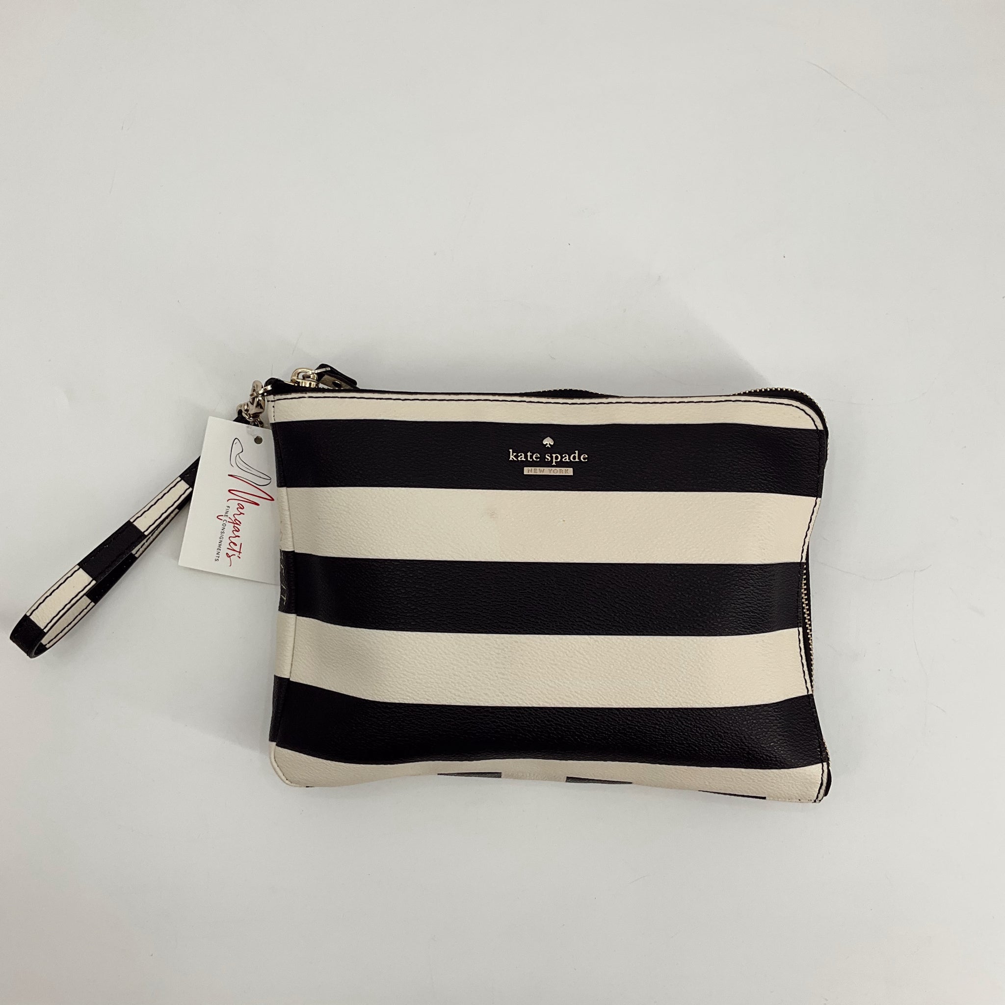 Kate Spade Black/White Stripe Clutch with wristlet strap, gently used and available at Margaret’s Fine Consignments. Bold striped design adds chic flair.