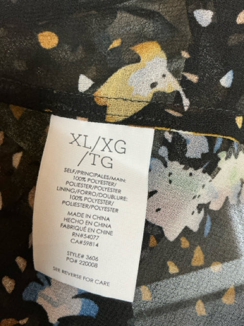 Fabric care and size tag of Cabi Black/Blue Ladies Pre-Owned Top - Size XL, showing polyester material and style number 3606.
