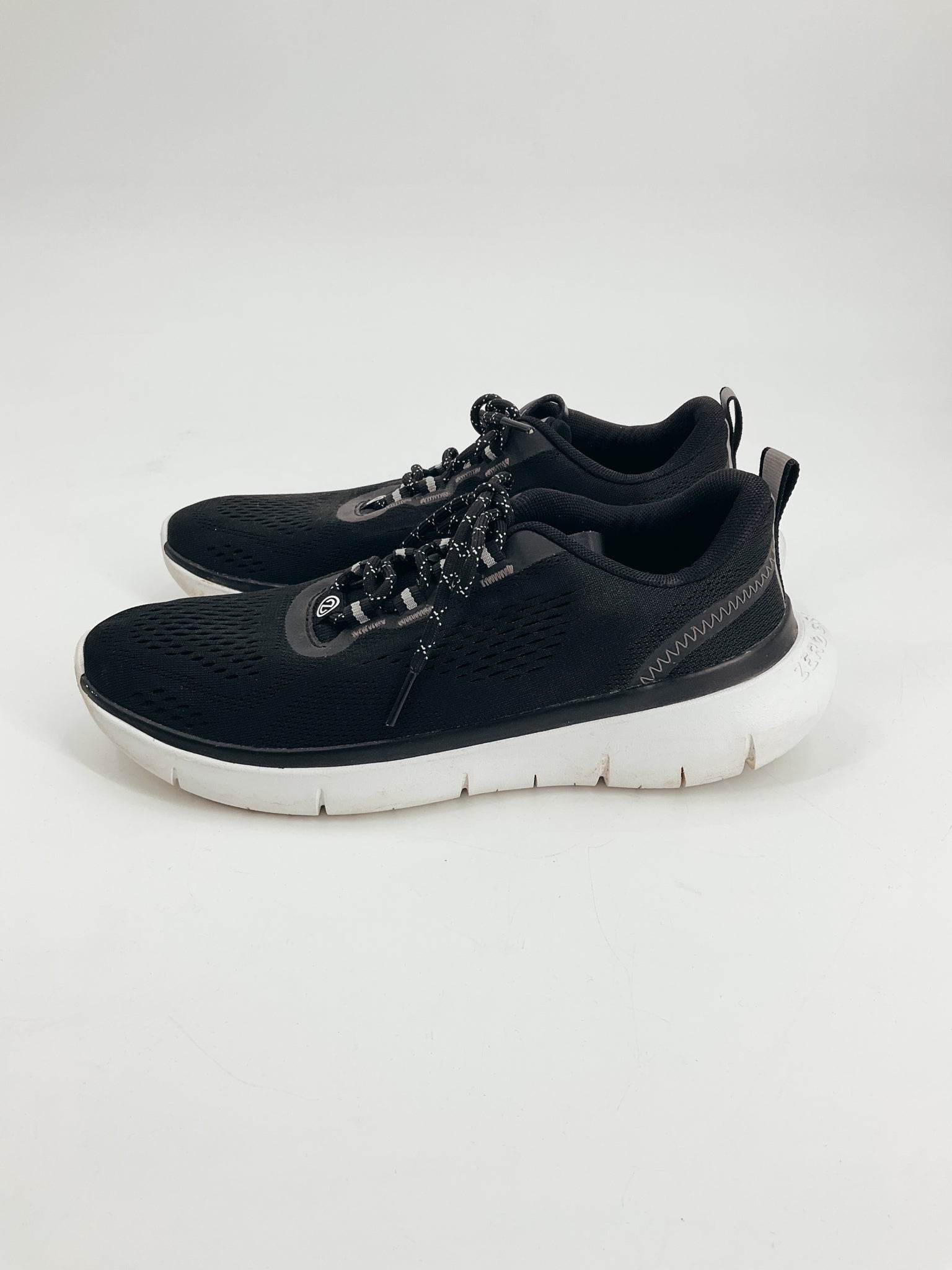 Cole Haan Black Pre-Owned Ladies Sneakers Size 8 with white soles and mesh upper, ideal for casual wear or light workouts.