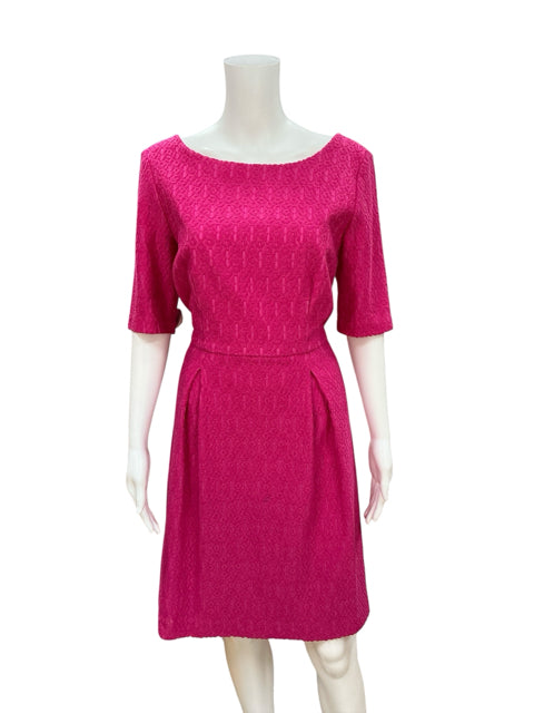 Front view of Trina Turk Pink Textured Pre-Owned Ladies Dress - Size 10, featuring jacquard fabric and pleated A-line skirt for cocktail events.