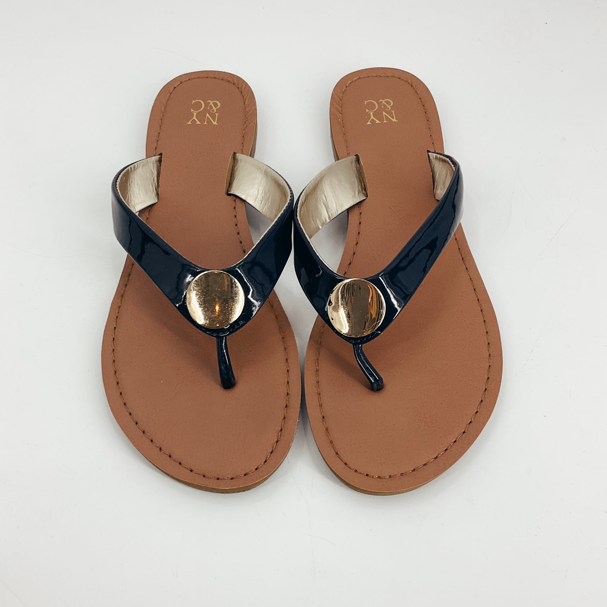 Top view of New York &amp; Co Navy Pre-Owned Ladies Sandals - Size 8 featuring glossy navy thong straps and gold disc detail on flat tan sole.