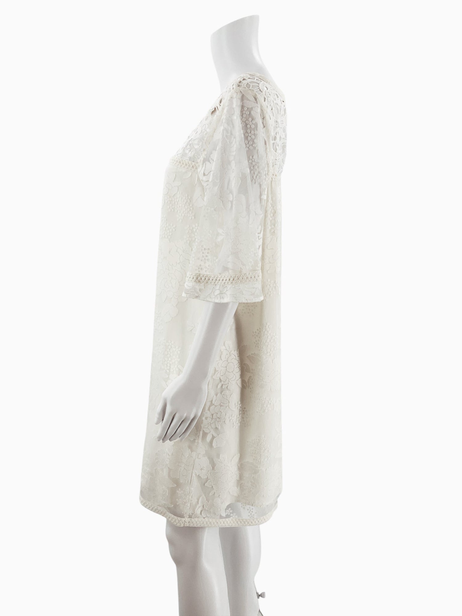 Side profile of Catherine Cream Floral Pre-Owned Ladies Dress highlighting boho shift cut and lace trim on sleeves and hem.