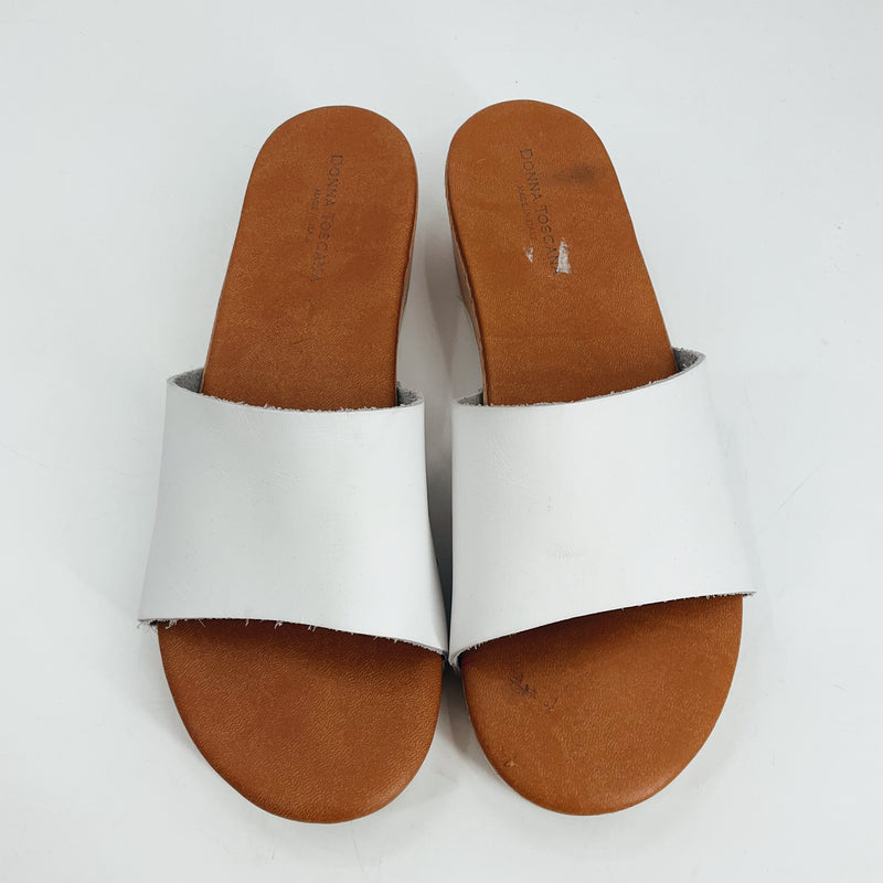 Top view of Donna Toscana white leather slide sandals, size 9. Features wide strap and cushioned insole for stylish European comfort.