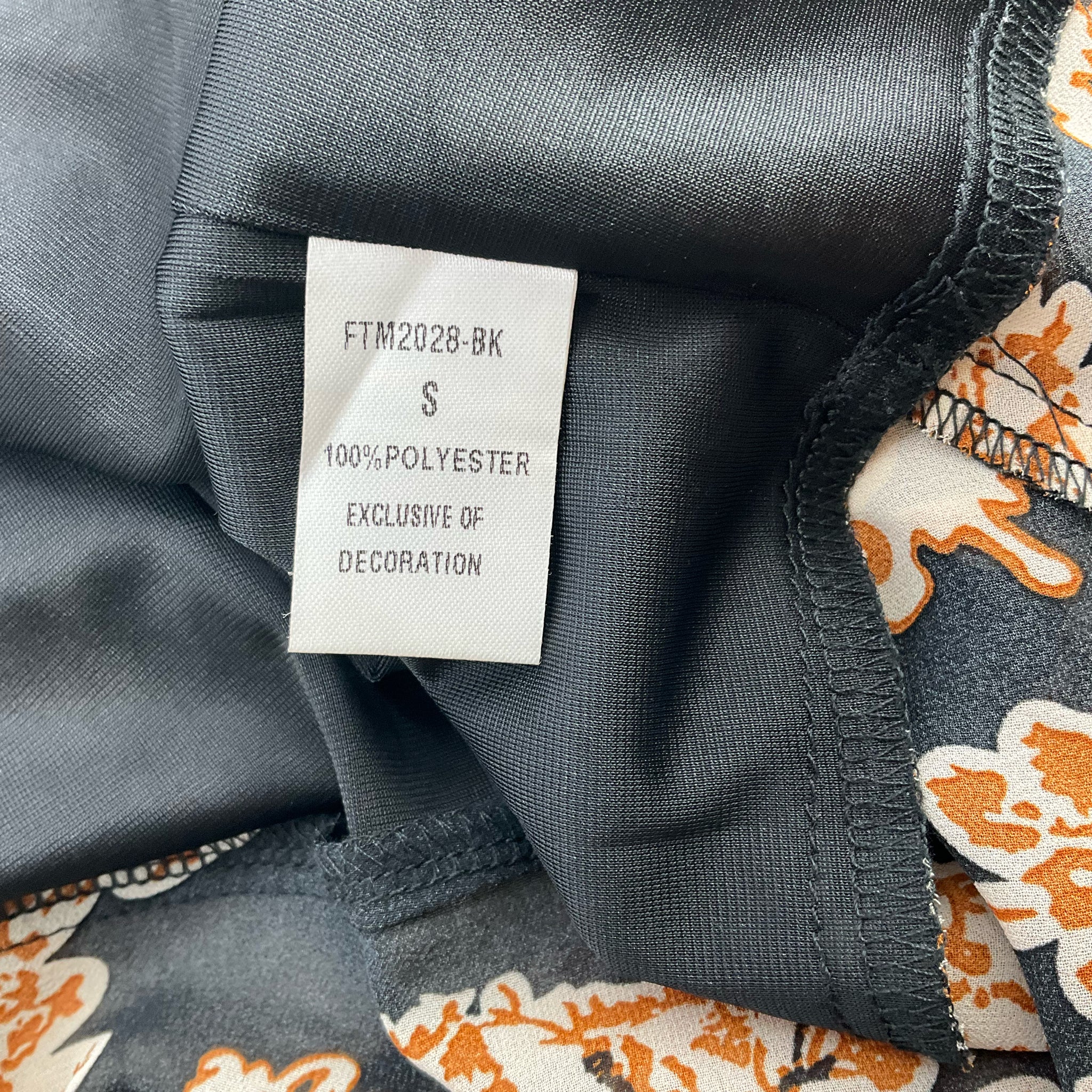 Fabric content tag of THML Black/Camel Flora Dress - Size Small showing 100% polyester material, exclusive of decoration, gently used condition.